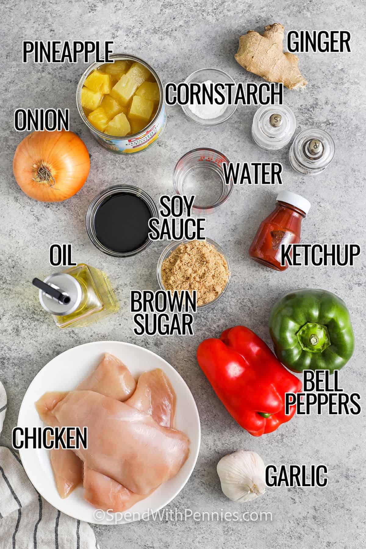 pineapple, cornstarch , ginger , water , onion , soy sauce , ketchup , oil, brown sugar , bell peppers , garlic and chicken with labels to make Sweet and Sour Chicken, with labels