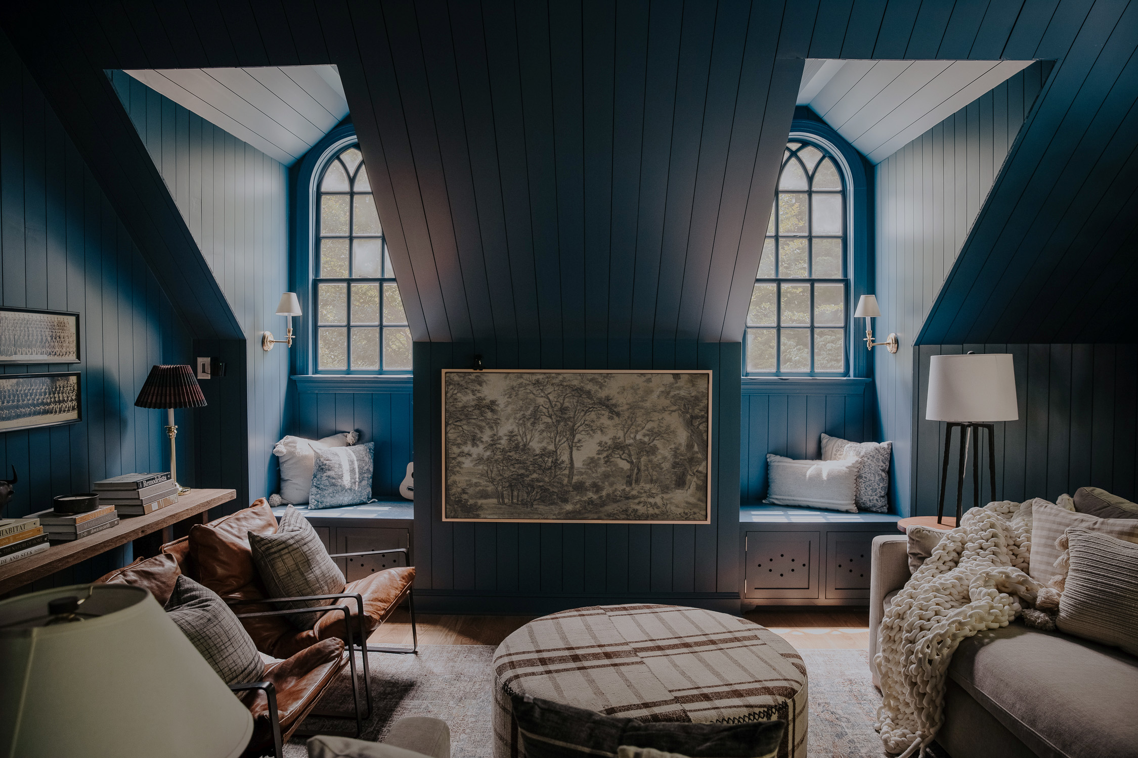The blue-paneled bonus room with a Frame TV featuring line trees.
