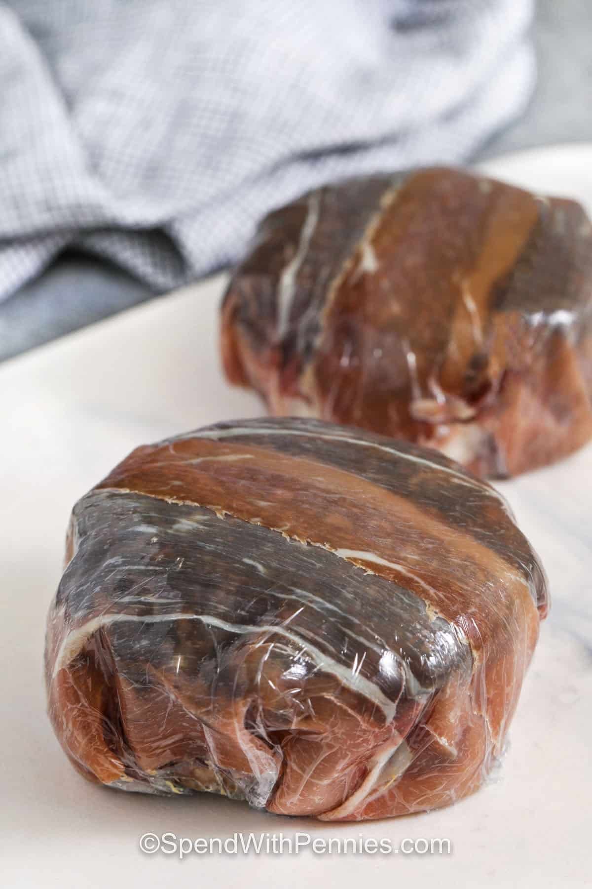This Beef Wellington recipe is a cozy favorite at our house. The rich mushroom mixture adds so much flavor, and that flaky pastry bakes up beautifully golden and crisp. It’s fancy without being fussy and absolutely perfect for a special dinner. Pair it with some roasted veggies or a crisp salad and you’ve got a meal everyone will remember. Don’t skip the Dijon—it gives a little extra zing! #spendwithpennies wrapping beef with prosciutto to make beef wellington