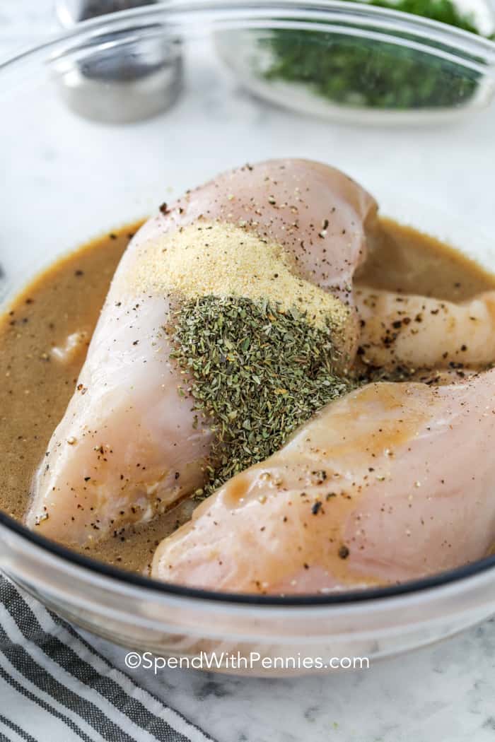 The best grilled chicken starts with this simple chicken marinade packed with bold, homemade flavor. With red wine vinegar, Italian seasoning, and Worcestershire sauce, it turns basic chicken breasts into a juicy, mouthwatering meal. Quick to prep and easy to cook, it's great for busy nights or weekend cookouts. Just marinate, grill, and enjoy! #spendwithpennies Chicken Marinade and seasonings over chicken breasts