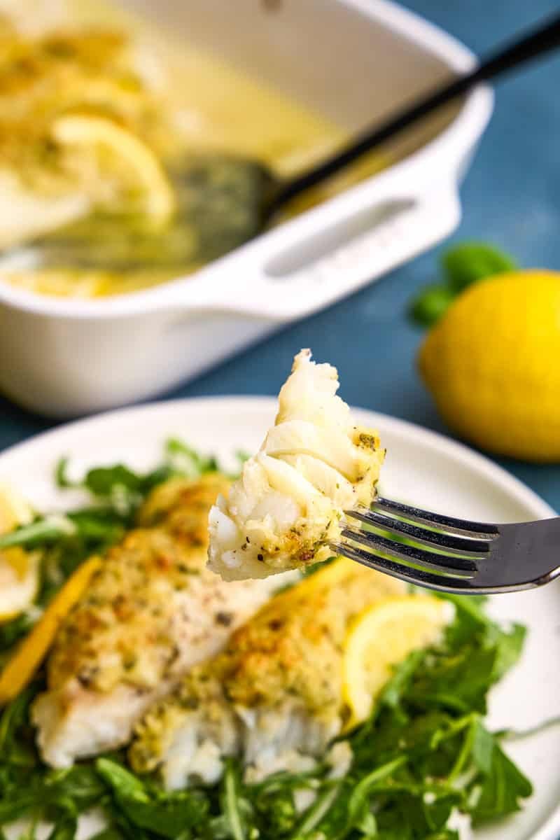 A bite of Easy Lemon Baked Cod Fish on a fork.