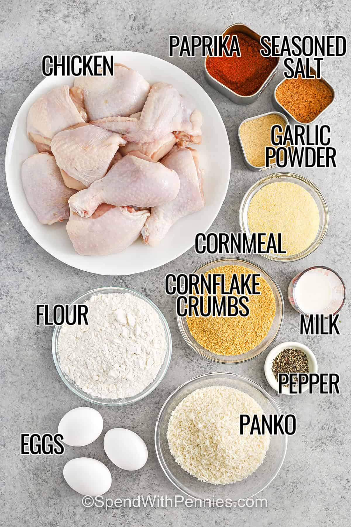 Oven fried chicken is crispy, golden, and packed with flavor thanks to a coating of Panko, cornflakes, and cornmeal. Seasoned with garlic, paprika, and pepper, each bite delivers juicy chicken inside a perfectly crunchy crust. It’s oven-baked to crispy perfection without deep frying. Perfect for a weeknight dinner or weekend treat! #spendwithpennies chicken , paprika , seasoned salt , garlic powder , panko , cornflake crumbs , milk , pepper , cornmeal , flour , eggs with labels to make Oven Fried Chicken