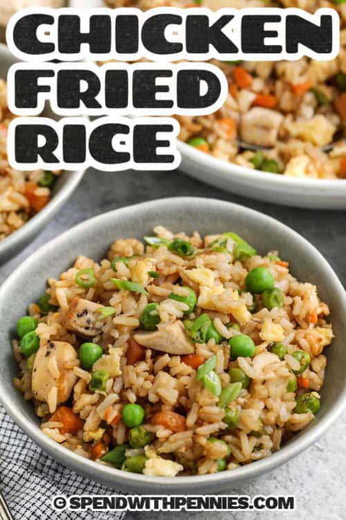 Chicken fried rice is the ultimate way to turn leftovers into something totally delicious. Cold cooked rice gets crisped up with veggies, scrambled egg, and a splash of savory soy sauce. Add cooked chicken, pork, or shrimp to make it hearty and satisfying. It’s easy to customize with what’s in your fridge. This recipe is a total win for busy weeknights! #spendwithpennies chicken fried rice in a bowl with writing
