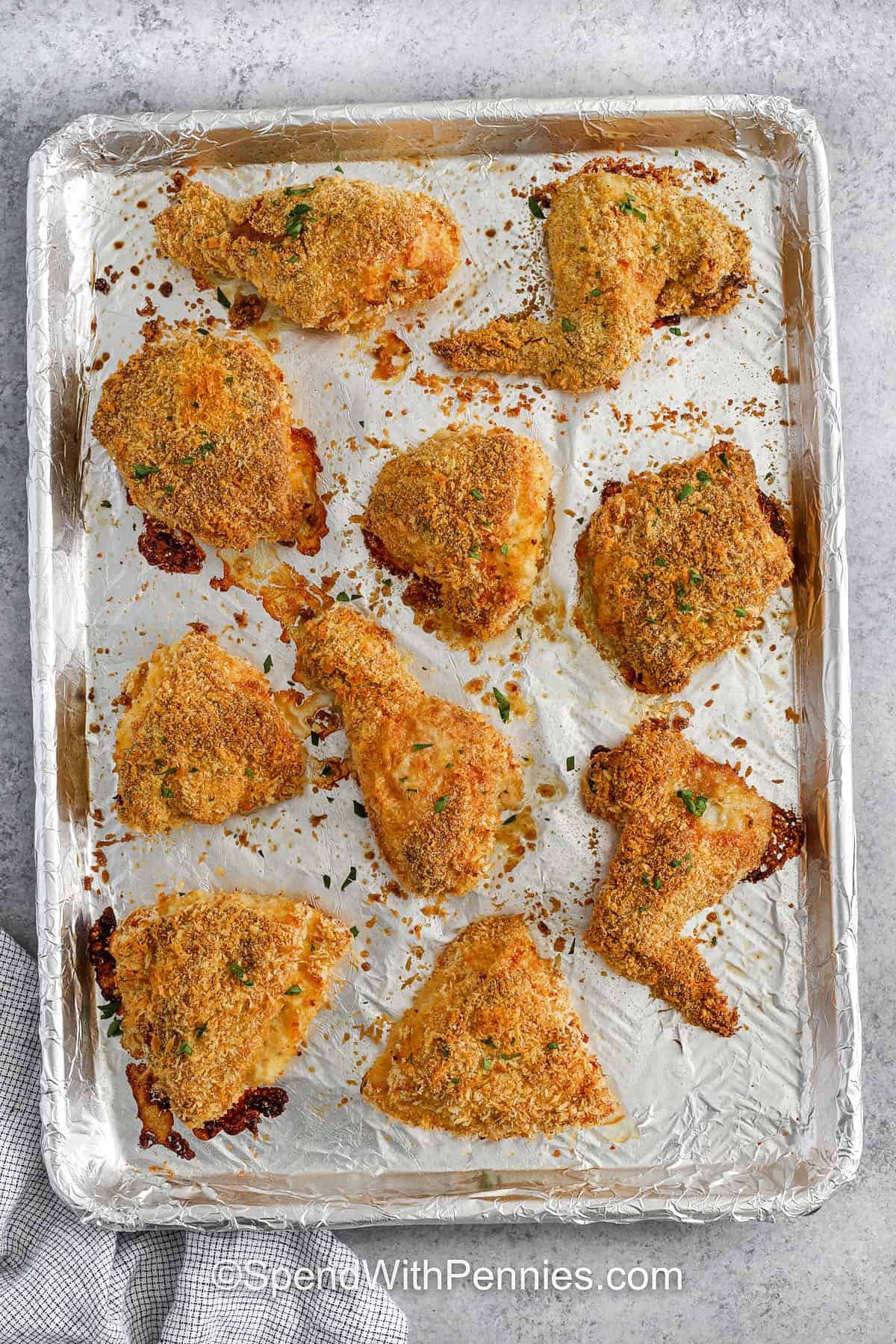 Oven fried chicken is baked, not fried, but still delivers all the crunchy goodness you love. With a flavorful mix of flour, spices, and crispy coatings, each bite is bursting with texture and taste. Sprayed with cooking oil or dotted with butter, the crust gets beautifully golden in the oven. A tasty and lighter twist on a comfort classic! #spendwithpennies sheet pan with crispy Oven Fried Chicken