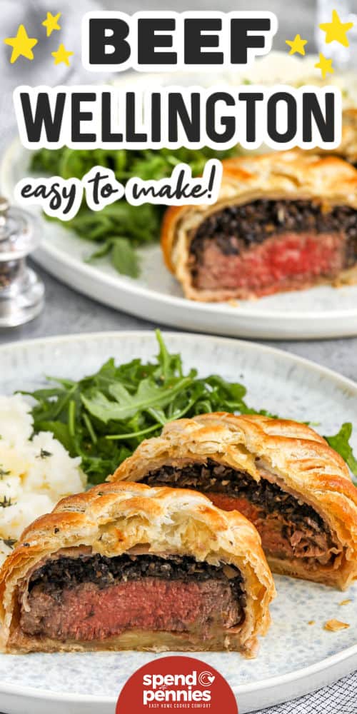 This delicious Beef Wellington recipe is a decadently delicious main course that's perfect for a special occasion. Tender beef wrapped in prosciutto and puff pastry with mushroom filling is a surefire hit with the whole family. Try it once and you'll make it again and again! #spendwithpennies beef wellington sliced on a plate with writing