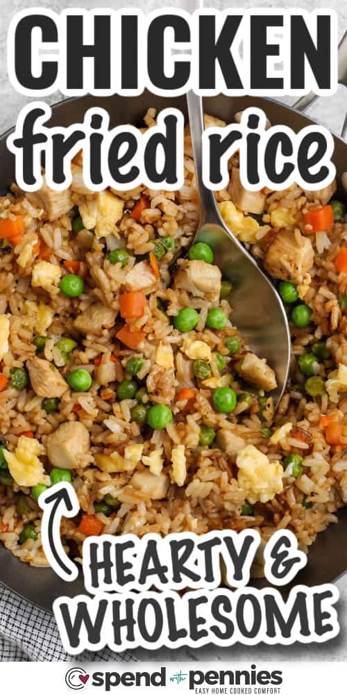 Chicken fried rice is one of those recipes you’ll turn to again and again. It’s quick, tasty, and made with pantry staples like frozen veggies and soy sauce. A little garlic, ginger, and toasted sesame oil bring tons of flavor. Great as a main or a side, and perfect for lunch the next day too! Leftovers never looked so good. #spendwithpennies closeup of chicken fried rice with a serving spoon and writing