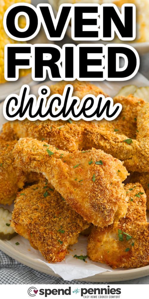 This oven fried chicken recipe is a crowd-pleaser that’s simple to make and packed with satisfying texture. The seasoned flour and crumb coating lock in moisture while giving every piece a bold, savory flavor. Skip the fryer and still enjoy crispy, juicy chicken straight from the oven. It’s comfort food made easy! #spendwithpennies close up of Oven Fried Chicken with a title