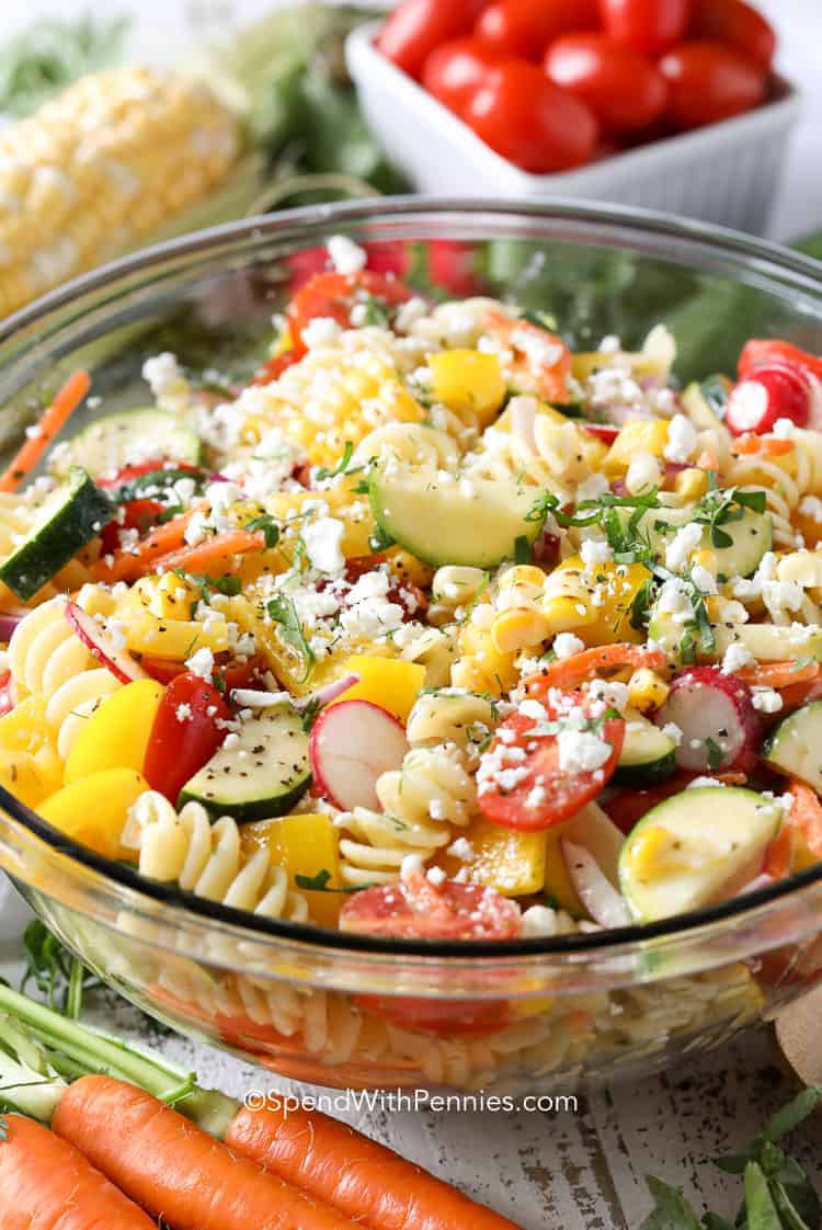 summer pasta salad in a glass serving bowl