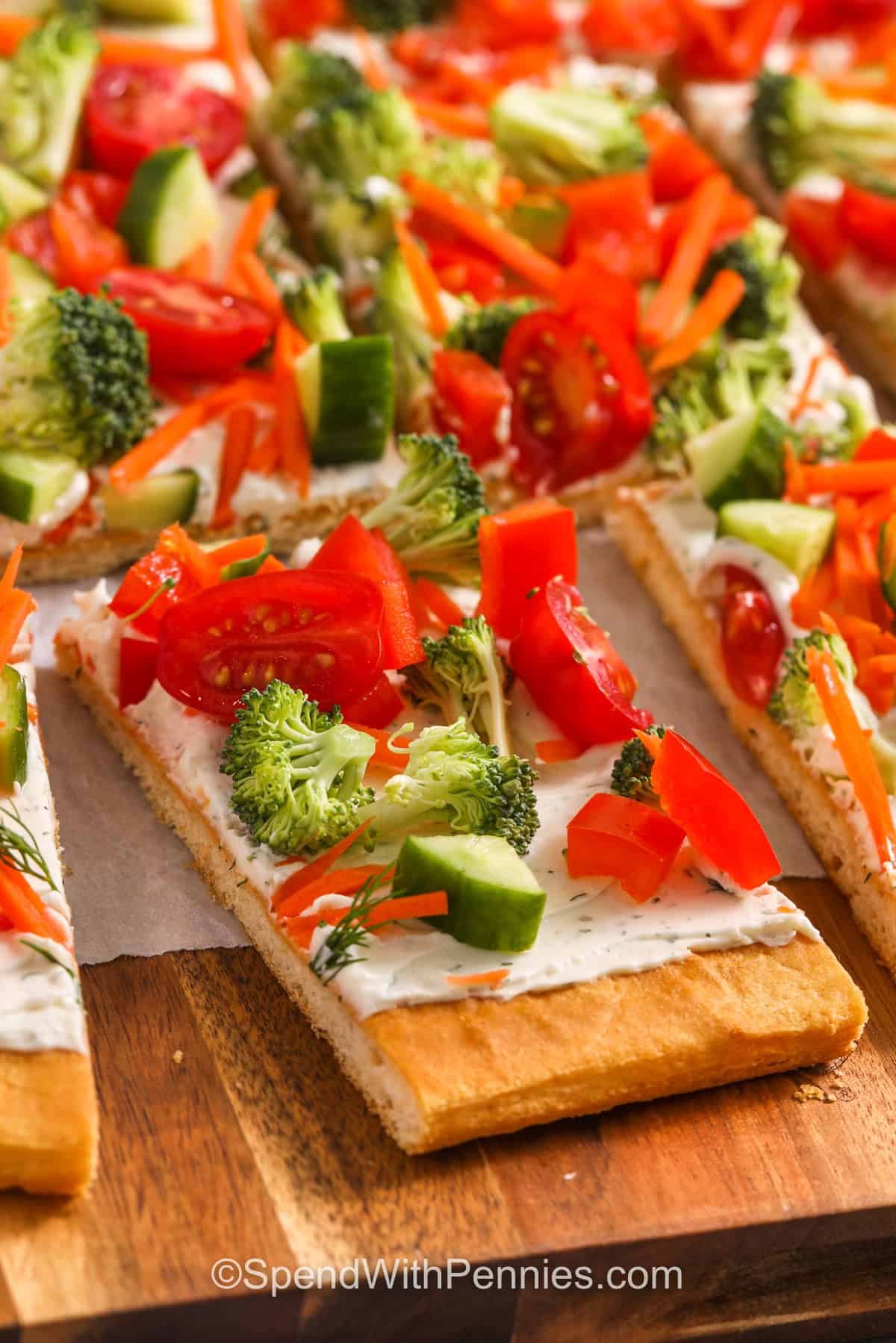 veggie pizza slices on a wooden serving tray