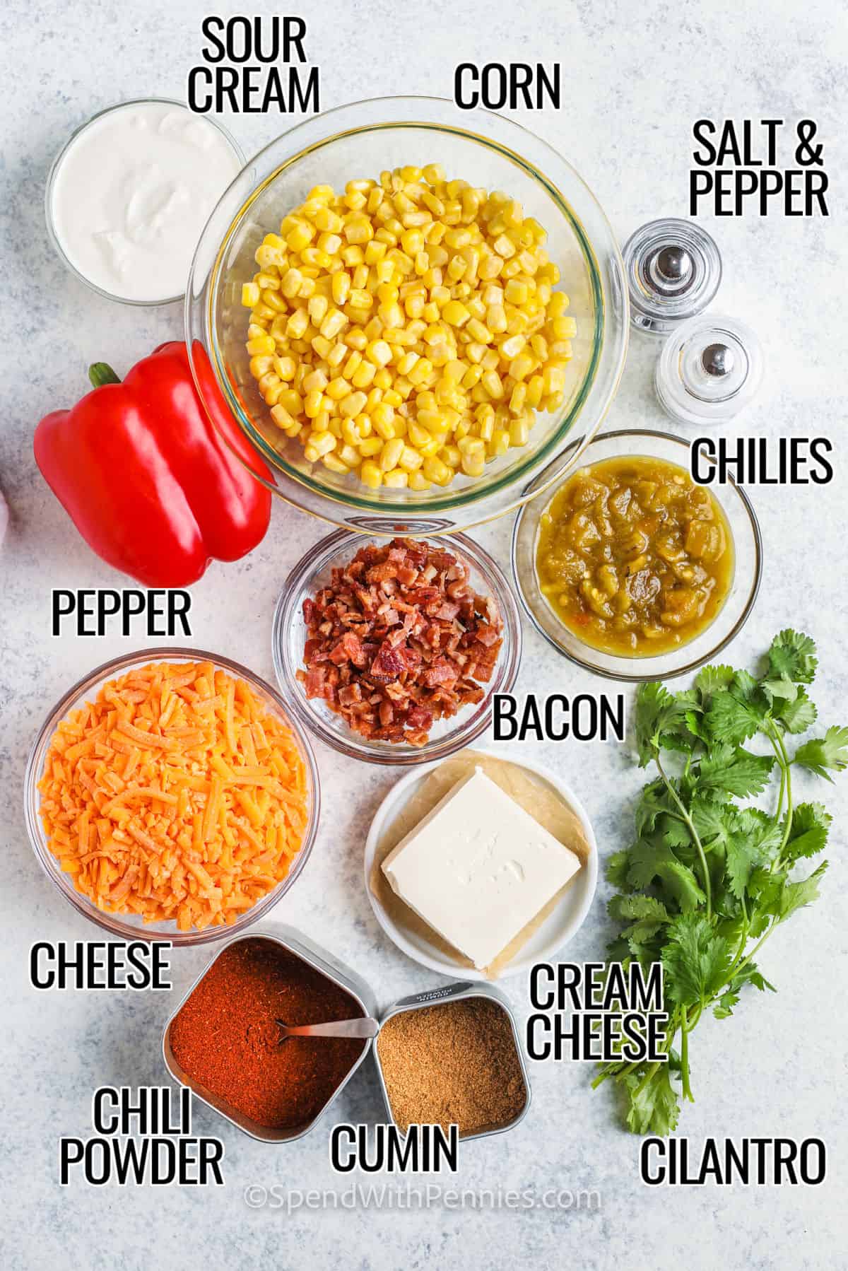 Corn dip is the perfect party recipe with flavors that remind you of Mexican street food. This hot dip combines corn, cream cheese, chiles, cheddar, bacon, and chili seasonings for a cheesy, spicy treat. Bake until melted and golden, then scoop it up with your favorite chips. Want to switch things up? Try adding ground beef or make a cold version for a refreshing twist on game day! #spendwithpennies sour cream , corn , pepper , chilies , bacon , cheese , cream cheese , cilantro and seasonings with labels to make Creamy Baked Corn Dip