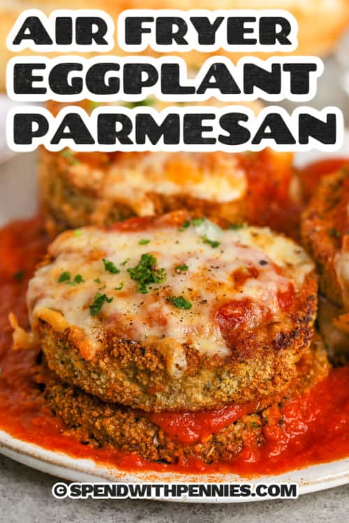 Get ready for easy air fryer eggplant parmesan to become your favorite way to make this delicious meal. Slices of eggplant are breaded in a savory breadcrumb mixture containing parmesan, herbs, and garlic powder, then they’re air fried until crispy. Top the slices with marinara sauce and mozzarella, and cook until melted. Try swapping thin chicken cutlets for the eggplant. For a keto version, leave out the bread crumbs. #spendwithpennies cheesy Air Fryer Eggplant Parmesan on a plate with sauce and a title