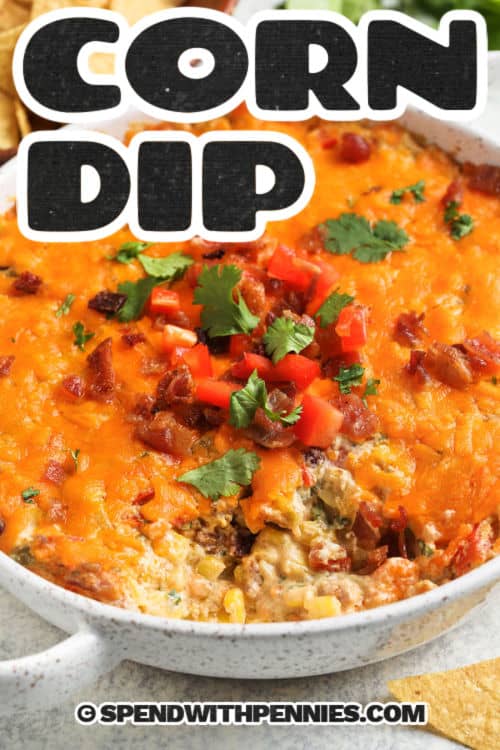 Creamy corn dip is a rich and cheesy hot dip featuring the bold flavors of Mexico. Sweet corn kernels are baked with cream cheese, sour cream, cheddar, bacon, chiles, cumin, and chili powder until bubbly and melted. Serve with sturdy chips and crackers for a hearty dip that is sure to satisfy. This corn dip recipe is perfect for parties and potlucks. Try it with black beans instead of bacon for a meatless version or bump up the heat with extra chili peppers. #spendwithpennies